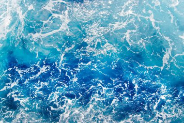 Blue frothy surface of sea water, shot in the open sea directly from above clipart