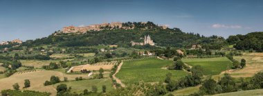 Panoramic view of the San Biagio church and hilltop town of Montepulciano in Tuscany, Italy clipart