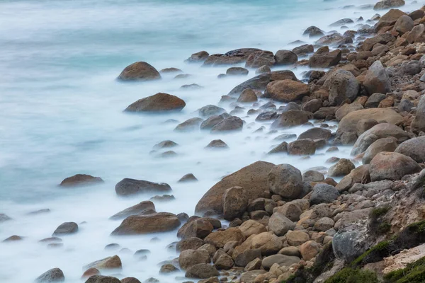 Long exposure of rocks and waves at Little Oberon bay in Wilsons Promontory national park, Victoria, Australia