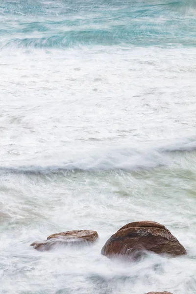 Long exposure of rocks and waves at Little Oberon bay in Wilsons Promontory national park, Victoria, Australia