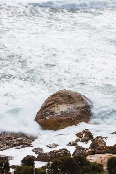 Long exposure of rocks and waves at Little Oberon bay in Wilsons Promontory national park, Victoria, Australia