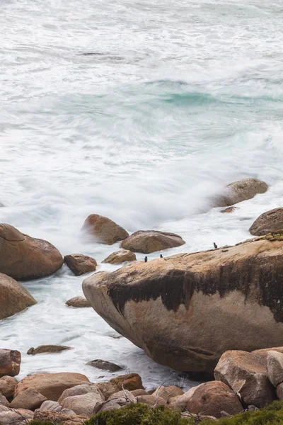 Long exposure of rocks and waves at Little Oberon bay in Wilsons Promontory national park, Victoria, Australia