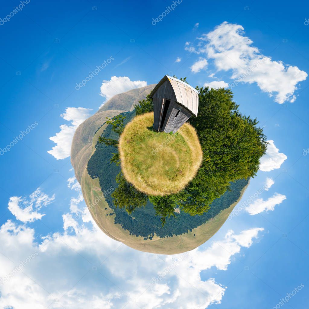woodshed on little planet spherical panorama. beautiful countryside concept with 360 degree view. abandoned building on a meadow among the forest in summer mountains