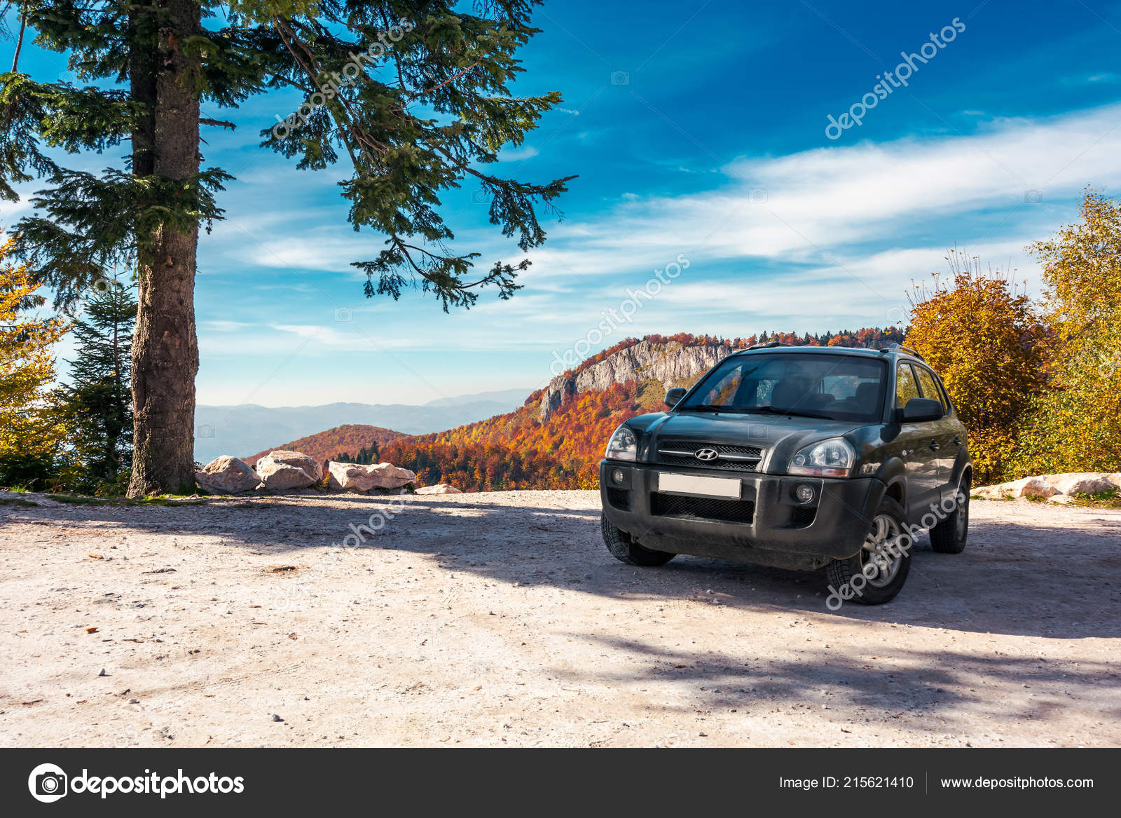 SUV on the parking lot in mountains Stock Editorial Photo © pellinni