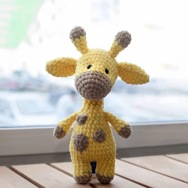 Crocheted amigurumi yellow giraffe. Knitted handmade toy
