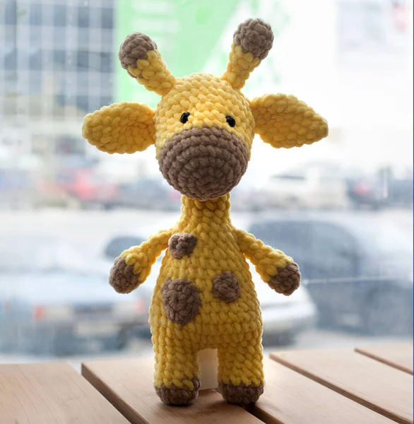 Crocheted amigurumi yellow giraffe. Knitted handmade toy