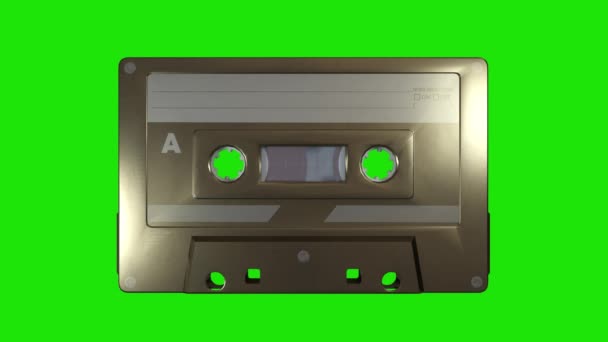 Un casete de música dorada sobre un fondo de pantalla verde — Vídeos de Stock