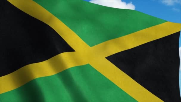 Bandera de Jamaica ondeando en el viento, fondo azul del cielo. 4K — Vídeo de stock