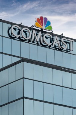ST. PAUL, MN/USA - SEPTEMBER 30, 2018: Comcast Corporation regional headquarters and trademark logo. clipart