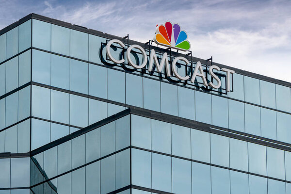 ST. PAUL, MN/USA - SEPTEMBER 30, 2018: Comcast Corporation regional headquarters and trademark logo.