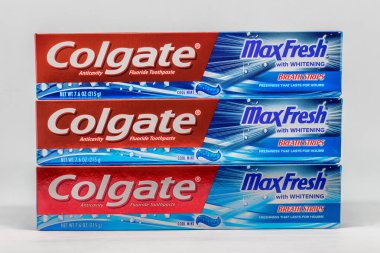 ST. PAUL, MN/USA - FEBRUARY 15, 2019: Grouping of three Colgate toothpaste boxes. Colgate-Palmolive Company is an American worldwide consumer products company. clipart