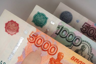 Rus banknotlar yakın çekim parçaları. 5000, 1000 ve 500 ruble faturaları gri bir arka plan üzerinde havada asılı. Arka plan üzerinde faturaları gölgesi düşer. Yukarıdan görüntülemek