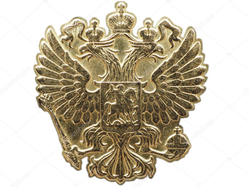 The national emblem of Russia from the yellow metal. Fragment of a coin close up. Isolated