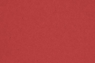 Koyu kırmızı karton yüzey. Selüloz lifli kağıt dokusu. Doymuş renk. Arkaplan ya da duvar kağıdı. Yukarıdan yukarıdan bir görüntü. Makro