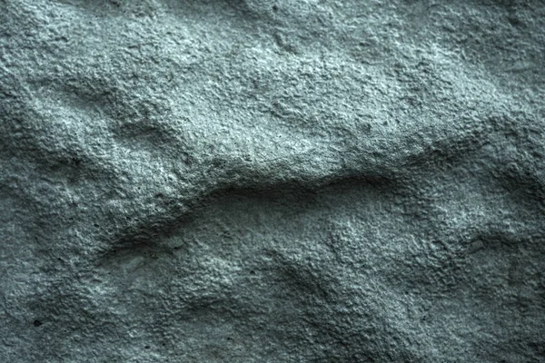 Bumpy and rough concrete block surface. Dark aged background or wallpaper. A dramatic gray-blue backdrop for a building, architectural or industrial theme. Rough foam material