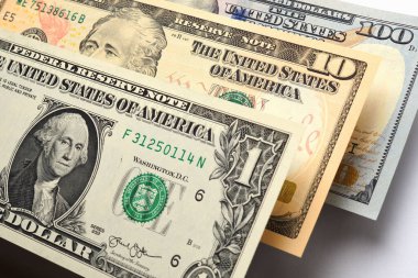 1, 10 ve 100 dolarlık Amerikan banknotları beyaz bir arka planda asılı duruyor. ABD 'de yatırım ve tasarruf. Parlak ve zengin bir illüstrasyon. Makro