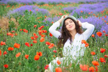 Kırmızı çiçekli haşhaş, güzel yaz manzara lavanta alanında genç kızdır