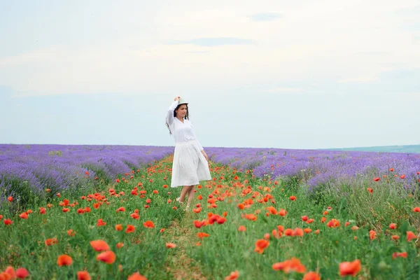 Kırmızı çiçekli haşhaş, güzel yaz manzara lavanta alanında genç kızdır