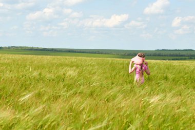 Buğday alan, parlak güneş, güzel yaz manzara ile yürüyüş çocuk