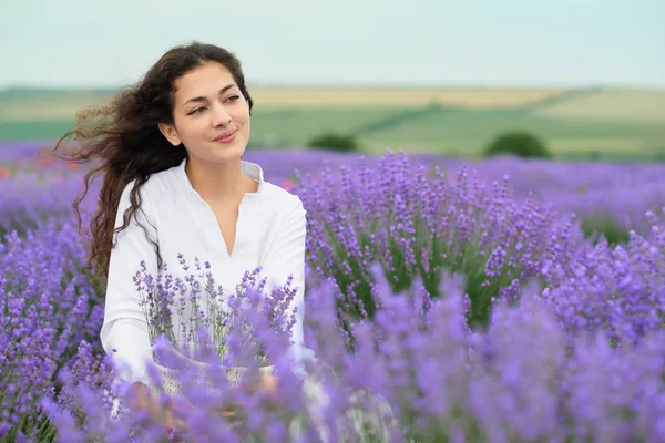 young woman is in the lavender field, beautiful summer landscape with red poppy flowers