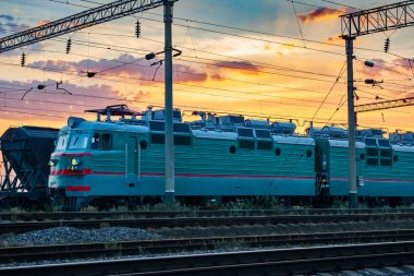 trenler ve vagonlar, demiryolu altyapısı, güzel gün batımı ve renkli gökyüzü, ulaşım ve Sanayi kavramı