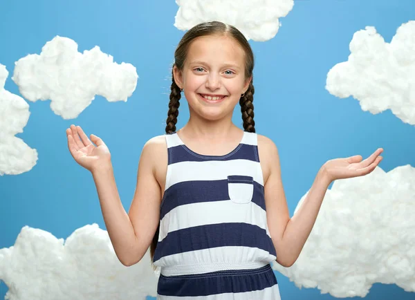 Girl Dressed Striped Dress Posing Blue Background Cotton Clouds Concept — Stock Photo, Image