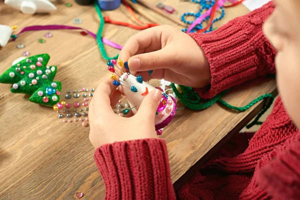 Childrens making decorations for new year holiday. Painting watercolors. Top view. Artwork workplace with creative accessories.