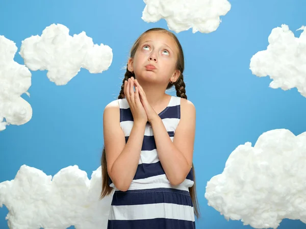 Girl Dressed Striped Dress Posing Blue Background Cotton Clouds Looking — Stock Photo, Image