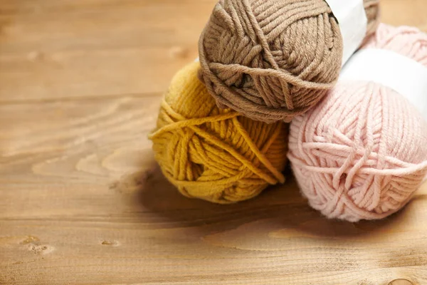 在木背景上编织的五颜六色的羊毛线 — 图库照片