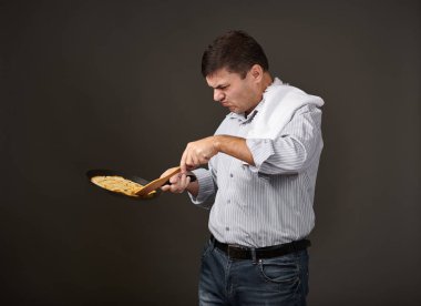man posing with a pancake in a pan, white shirt and pants, gray background, surprised emotions clipart