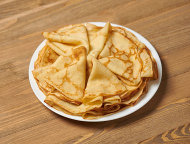 Krep portre, bir tabak, ahşap arka plan üzerinde ince krep yığını