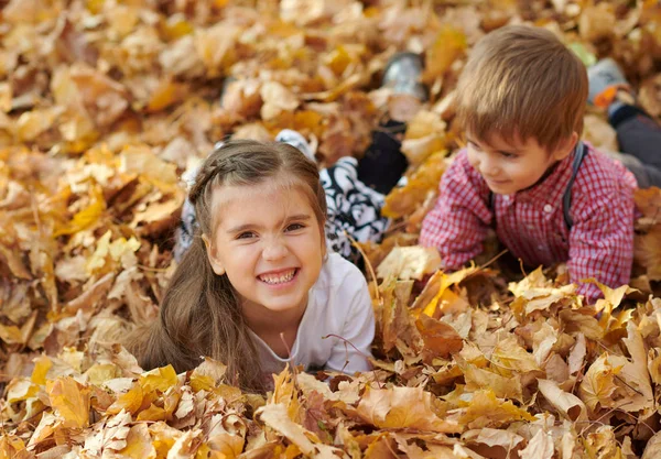 Children Lying Palying Fallen Leaves Autumn City Park — Stock Photo, Image