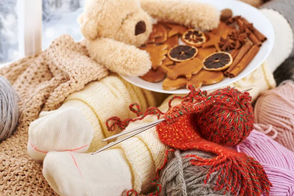 Child legs in warm socks are on a window sill with wool yarns. — Stock Image Child Legs Warm Socks Window Sill Wool Yarns Stock Photo