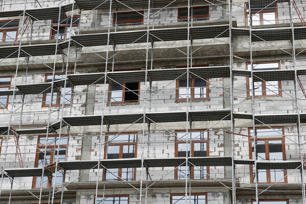 new building under construction, scaffolding and concrete