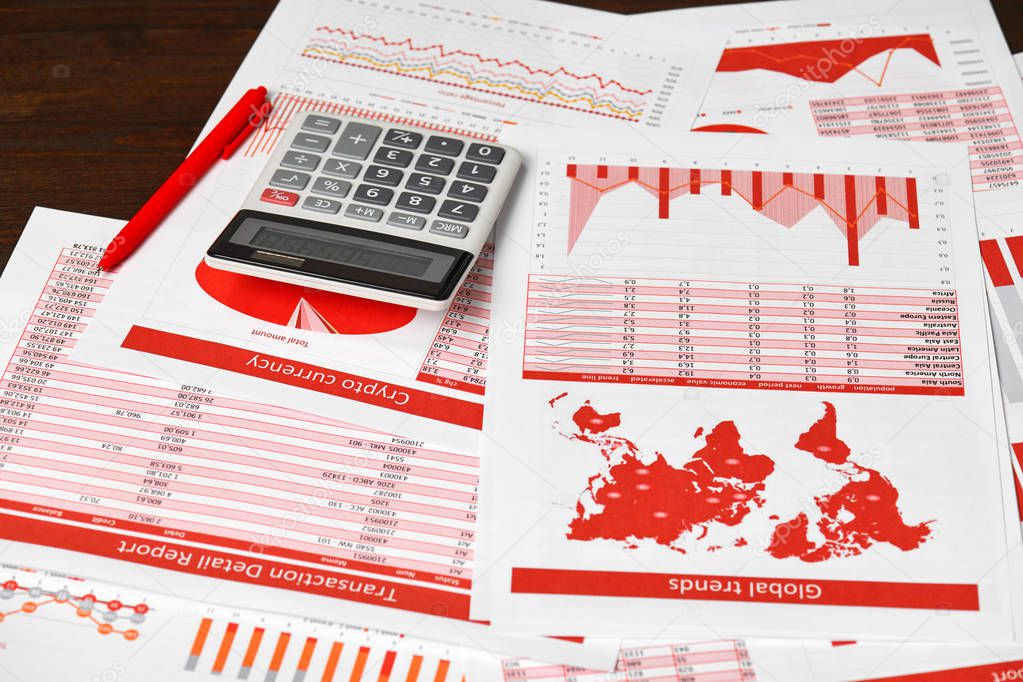 Red reports, graphs and calculator for calculating finance on desk office. Business financial accounting concept