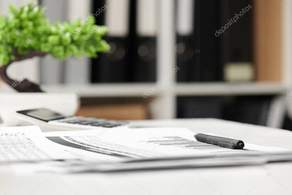 Office interior, closeup table with reports. Business financial accounting concept.