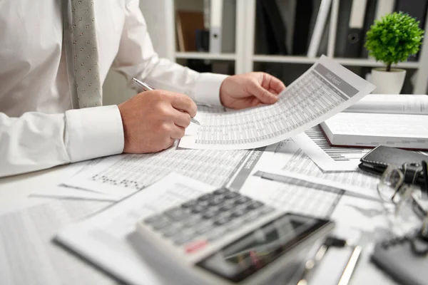 Uomo d'affari che lavora in ufficio e calcola la finanza, legge e scrive rapporti. Concetto contabile finanziario aziendale . — Foto Stock