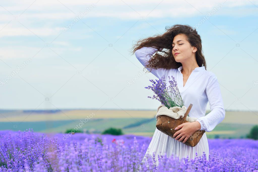 young woman is in the lavender flower field, beautiful summer landscape