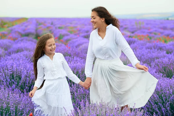 Niñas están en el campo de flores de lavanda, hermoso paisaje de verano — Foto de Stock