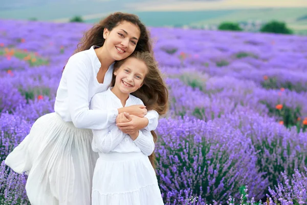 Girls are in the lavender flower field, beautiful summer landscape — Stock Photo, Image