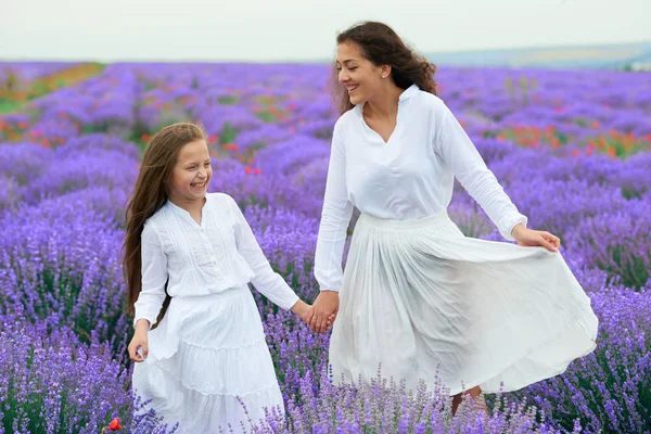 Niñas están en el campo de flores de lavanda, hermoso paisaje de verano — Foto de Stock