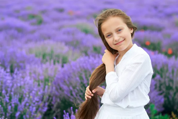 Girl child is in the lavender flower field, beautiful summer landscape — Stock Photo, Image