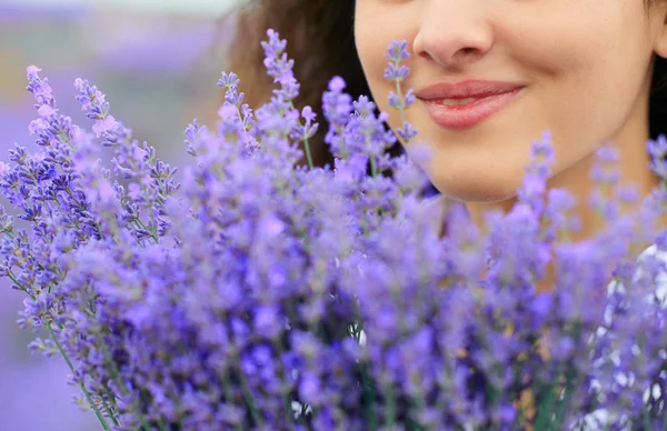 Beautiful woman face with lavender flower — Stock Photo, Image