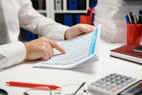 Geschäftsmann arbeitet und rechnet, liest und schreibt Berichte. Büroangestellte, Tischnaht. Finanzbuchhaltungskonzept für Unternehmen. — Stockfoto