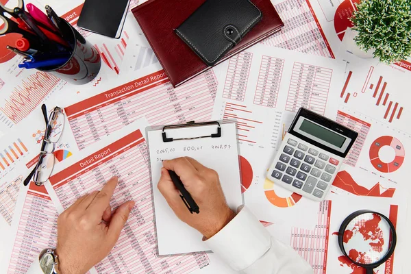 Business reports, data tables and charts - directly above view of office table workspace. — Stock Photo, Image