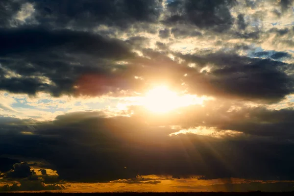 Schöner Sonnenuntergang - dunkler Himmel mit Wolken und Sonnenlicht — Stockfoto