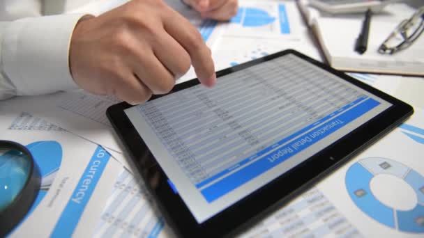 Businessman working and calculating, reads and writes reports. Using tablet pc. Office employee, table closeup. Business financial accounting concept.