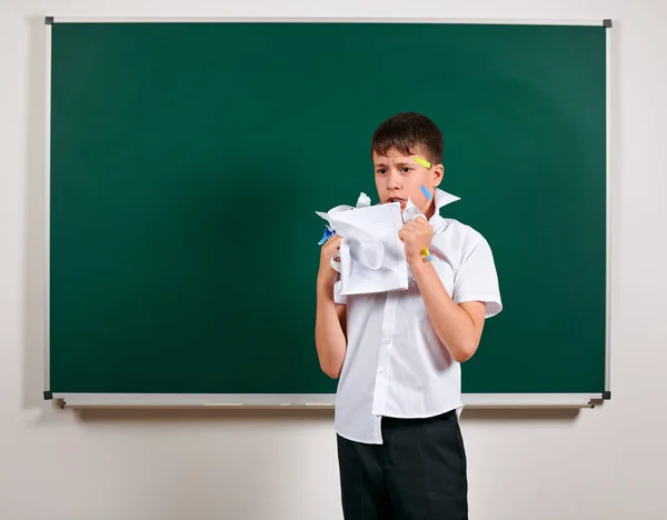 Portrait of funny pupil. School boy very emotional, having fun and very happy, blackboard background - back to school and education concept — Stock Photo, Image