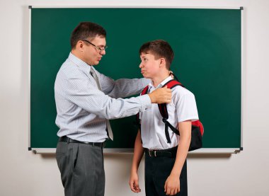 Bir öğretmen ve okul çocuğu kara tahta arka planda oynayan portresi - geri okul ve eğitim kavramı