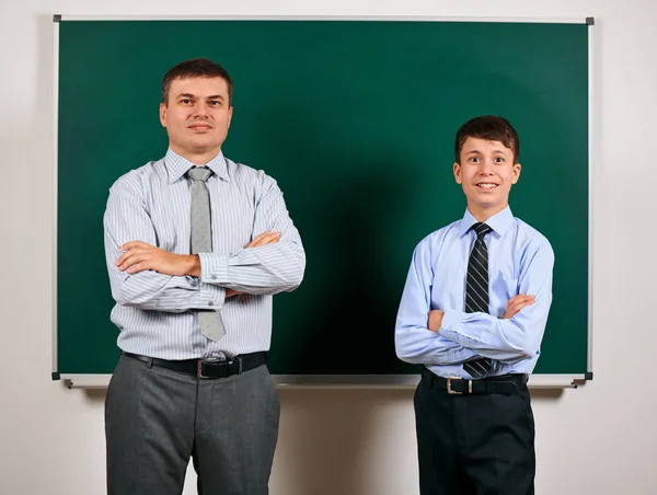 Retrato de um homem e um menino vestidos com fatos de negócios perto do fundo do quadro-negro - conceito de aprendizagem e educação — Fotografia de Stock